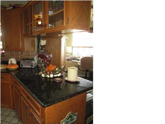 1054 Melton Road Baker, FL 32531 - Photo 24 of 34 a kitchen area with granite countertop a sink and cabinets