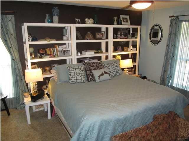 1054 Melton Road Baker, FL 32531 - Photo 31 of 34 a bed sitting in a bedroom next to a window with a book shelf