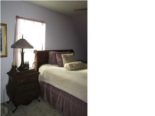 1054 Melton Road Baker, FL 32531 - Photo 32 of 34 a bedroom with a bed and a window