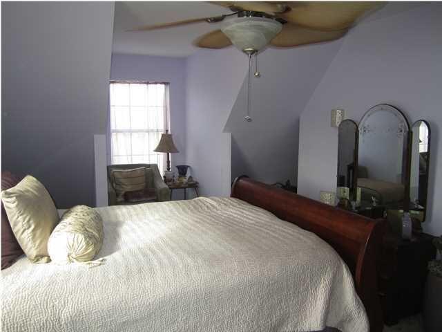 1054 Melton Road Baker, FL 32531 - Photo 33 of 34 a bedroom with a bed and wooden floor