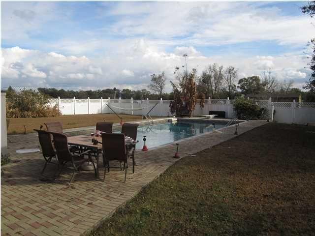 1054 Melton Road Baker, FL 32531 - Photo 34 of 34 a view of a terrace with furniture and a stove