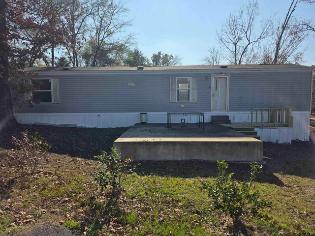 a view of a house with a yard and sitting area