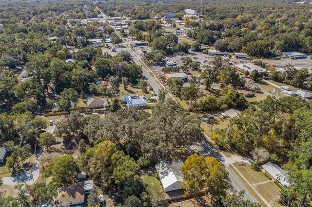 a kitchen with stainless steel appliances a table and chairs in it