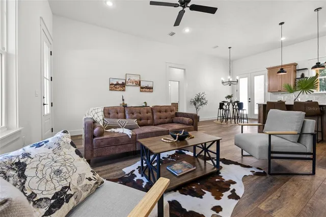 a kitchen with stainless steel appliances granite countertop a stove a sink a refrigerator and a wooden cabinets