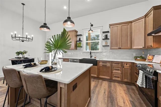 a bathroom with a double vanity sink mirror and bathtub