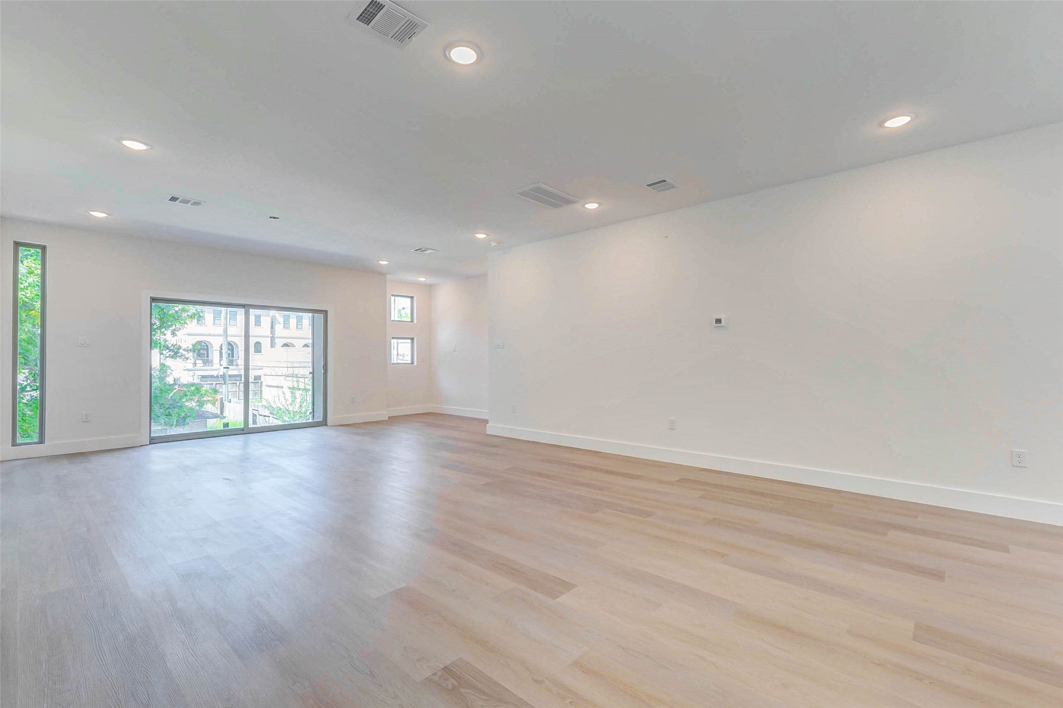 5638 Dolores Street Houston, TX 77057 - Photo 12 of 47 an empty room with wooden floor and windows
