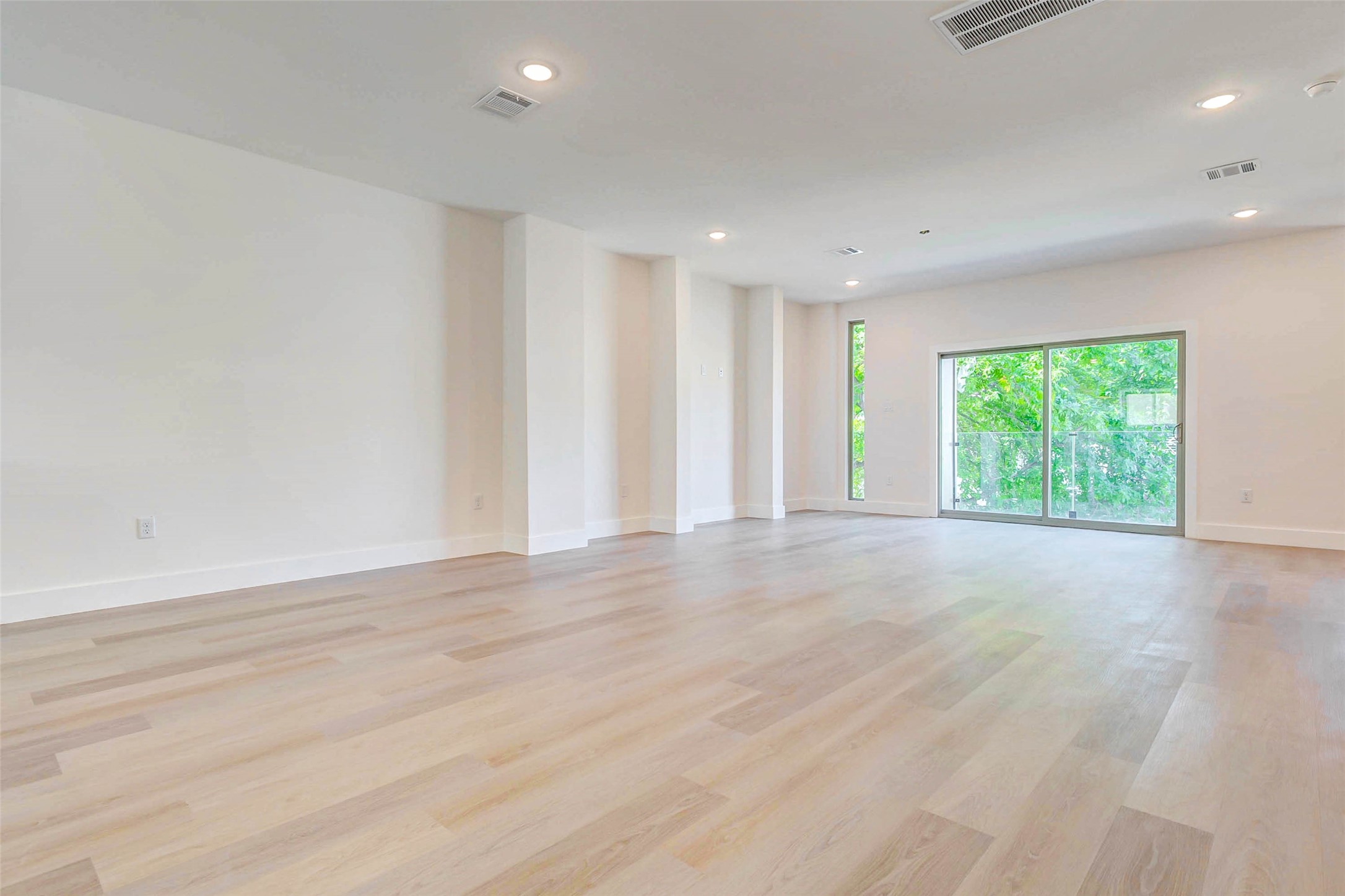 5638 Dolores Street Houston, TX 77057 - Photo 14 of 47 a view of an empty room with wooden floor and a window