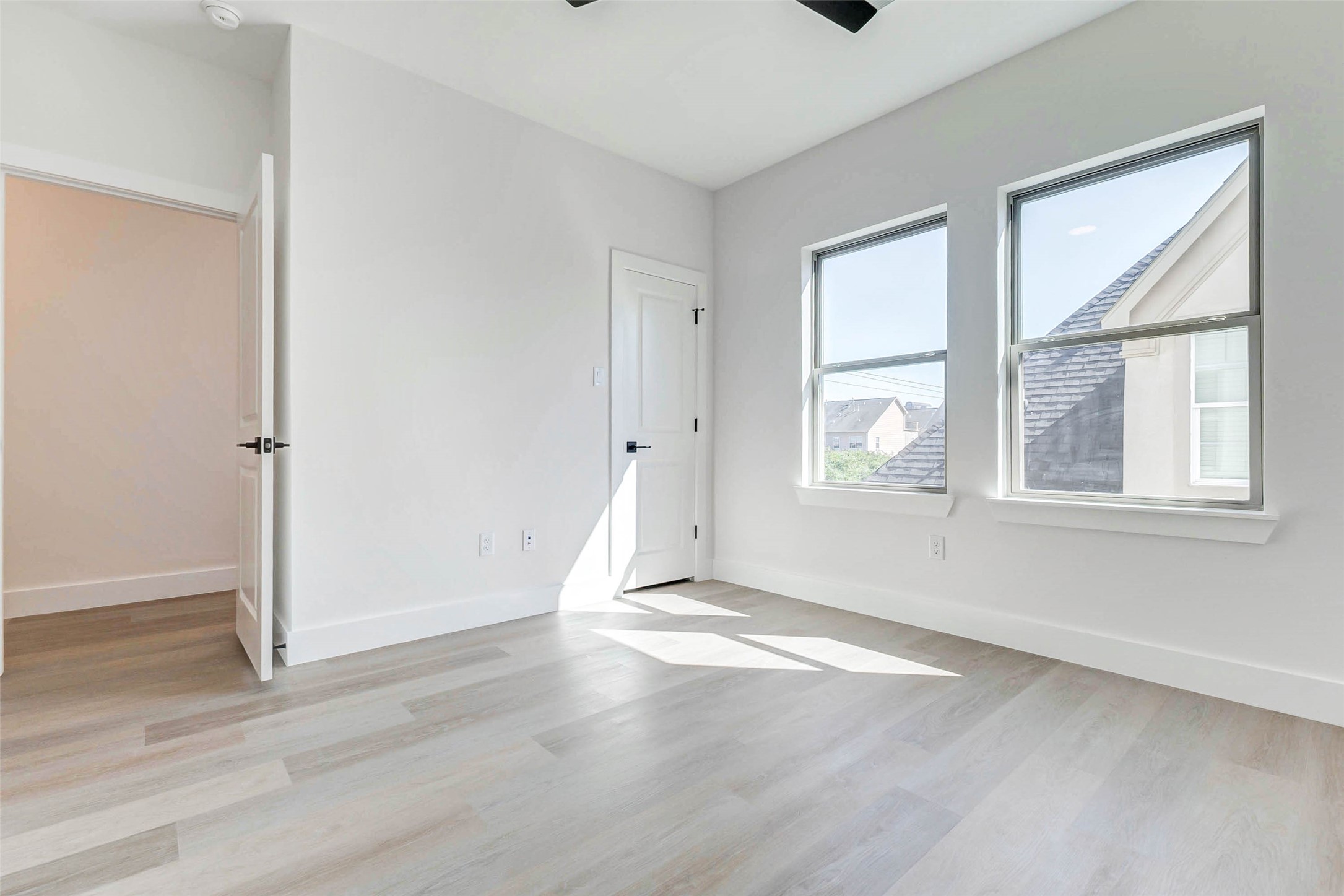 5638 Dolores Street Houston, TX 77057 - Photo 20 of 47 an empty room with wooden floor and windows
