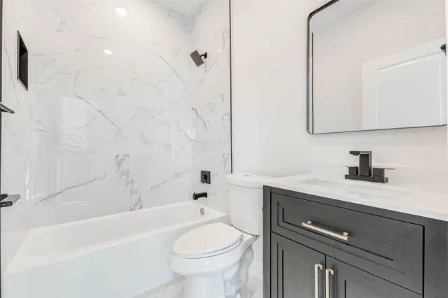 a bathroom with a sink a toilet and a bathtub