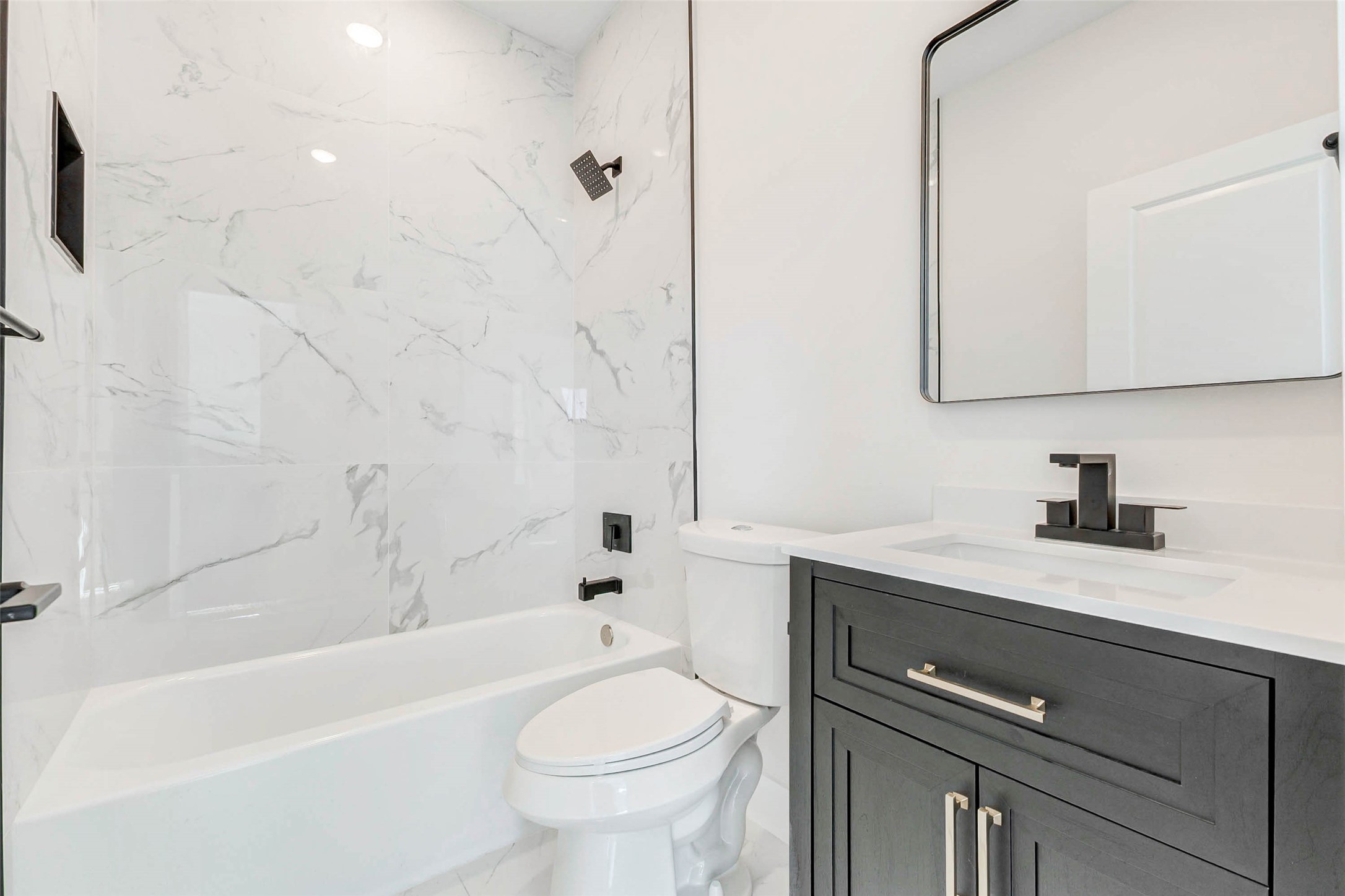 5638 Dolores Street Houston, TX 77057 - Photo 21 of 47 a bathroom with a sink a toilet and a bathtub