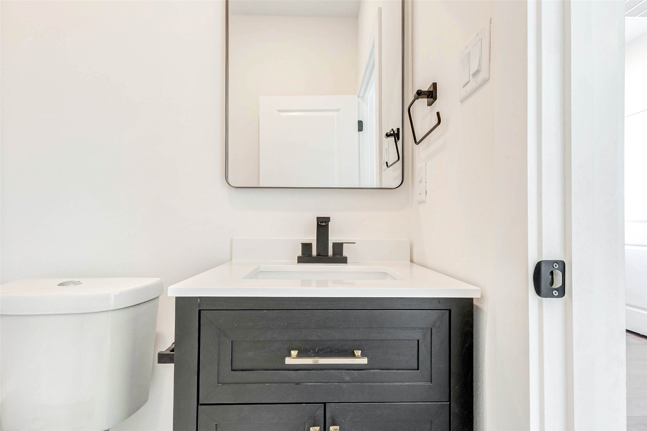 5638 Dolores Street Houston, TX 77057 - Photo 22 of 47 a bathroom with a sink vanity and a toilet
