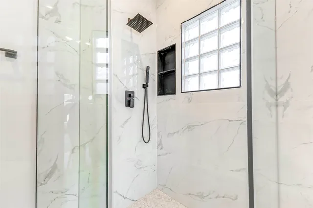 a bathroom with a shower and a sink