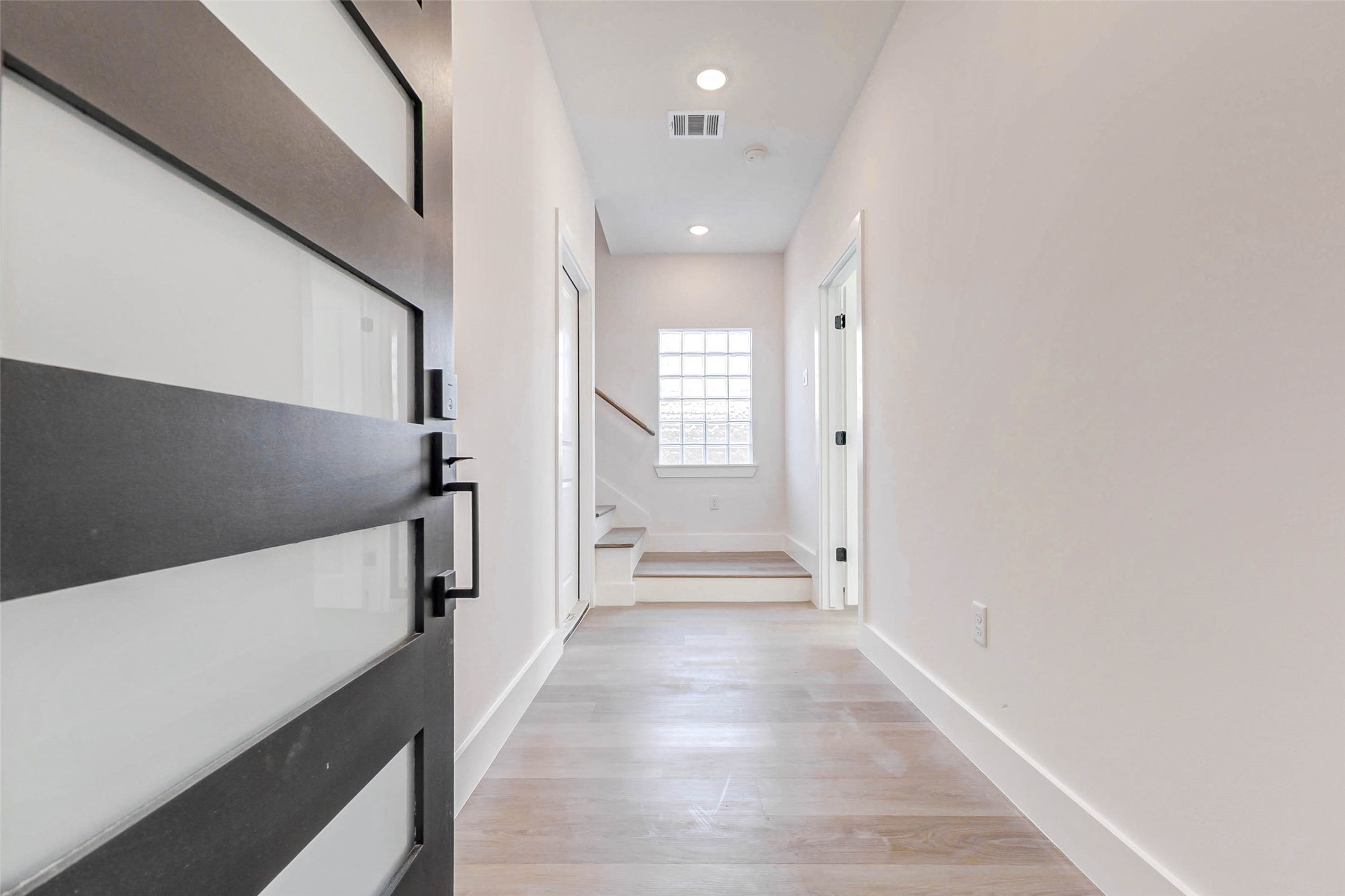 5638 Dolores Street Houston, TX 77057 - Photo 3 of 47 a view of a hallway with wooden floor and staircase