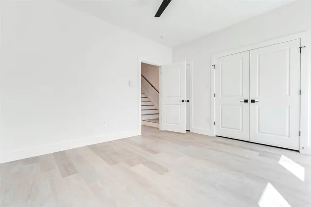 a view of an empty room with wooden floor