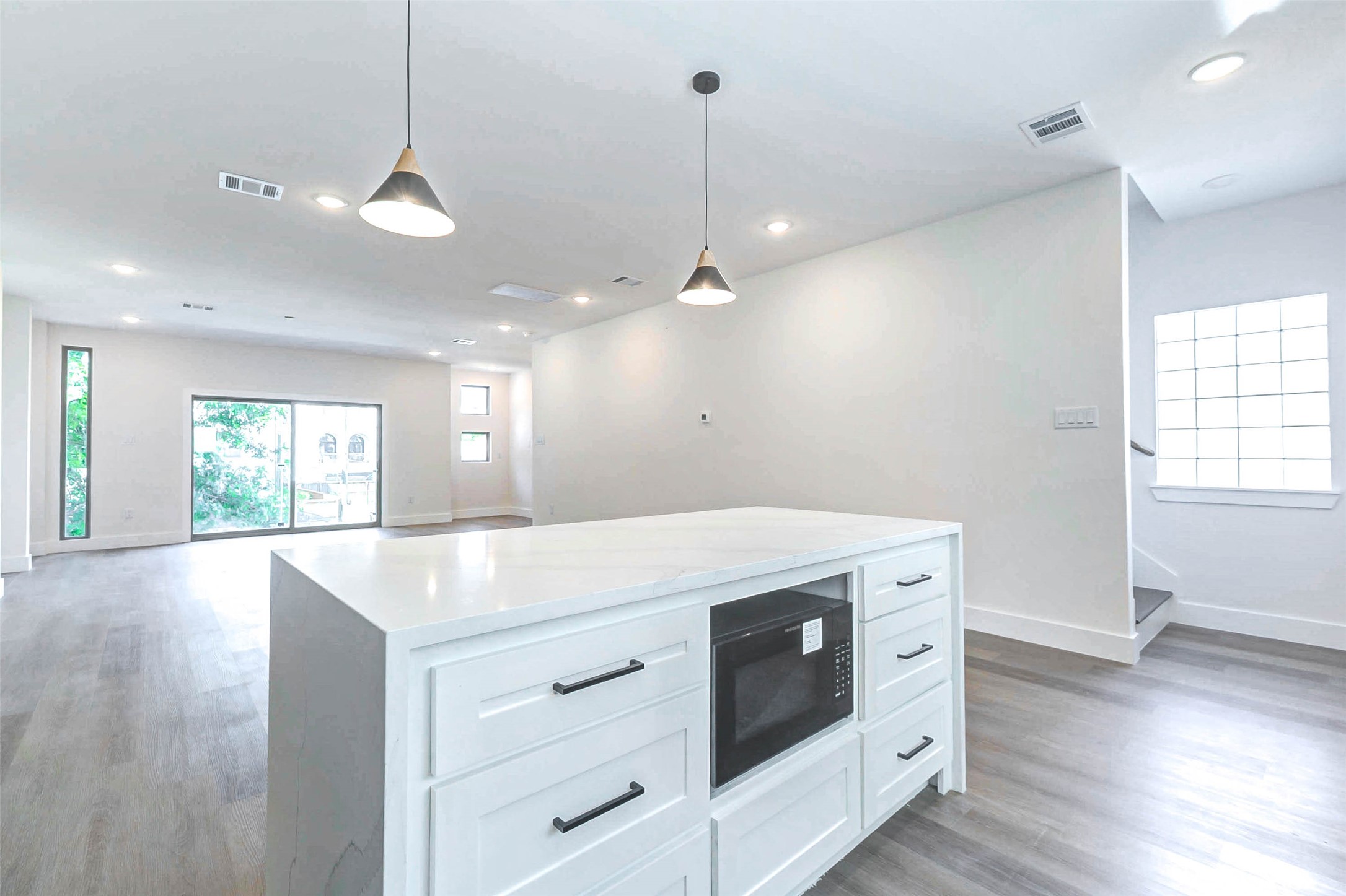 5638 Dolores Street Houston, TX 77057 - Photo 7 of 47 a kitchen with a stove a sink a window and wooden floor
