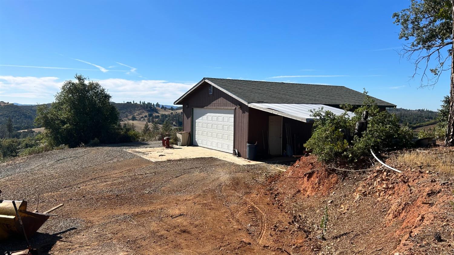 9080 El Dorado Trail Mountain Ranch, CA 95246 - Photo 12 of 48 a front view of a house with a yard