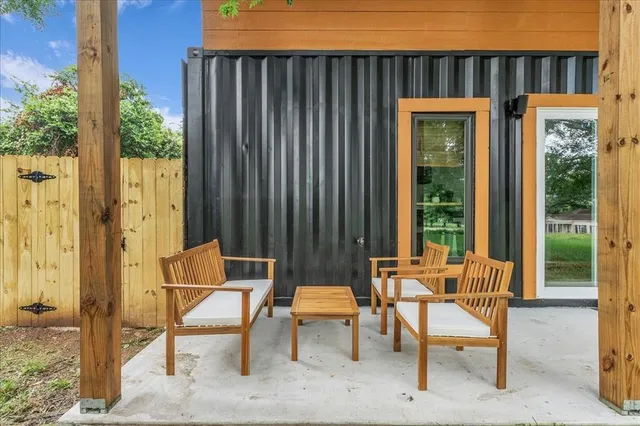 a backyard of a house with table and chairs