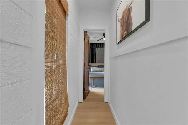 a view of a hallway with wooden floor and staircase