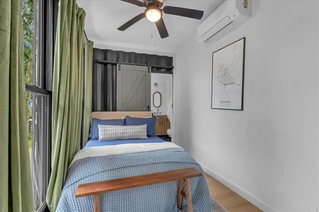 a bedroom with a bed and a chandelier