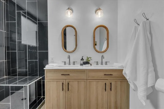 a bathroom with a double vanity sink and a mirror