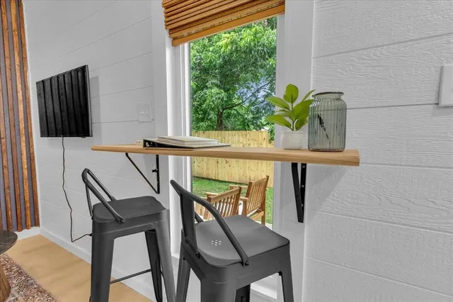 a view of a chairs and table in the balcony