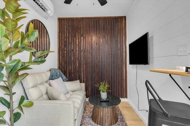 a living room with furniture and a flat screen tv