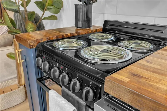 a kitchen with a stove and a mirror