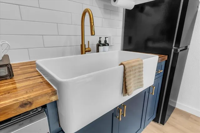 a bathroom with a double vanity sink a toilet and a mirror