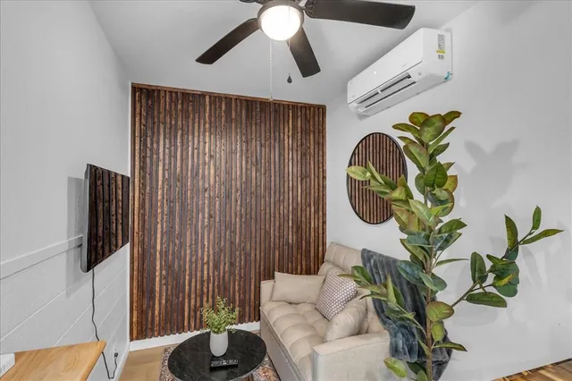 a living room with furniture and a potted plant