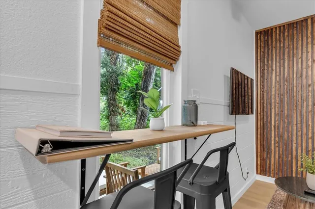 a view of balcony with furniture and a window