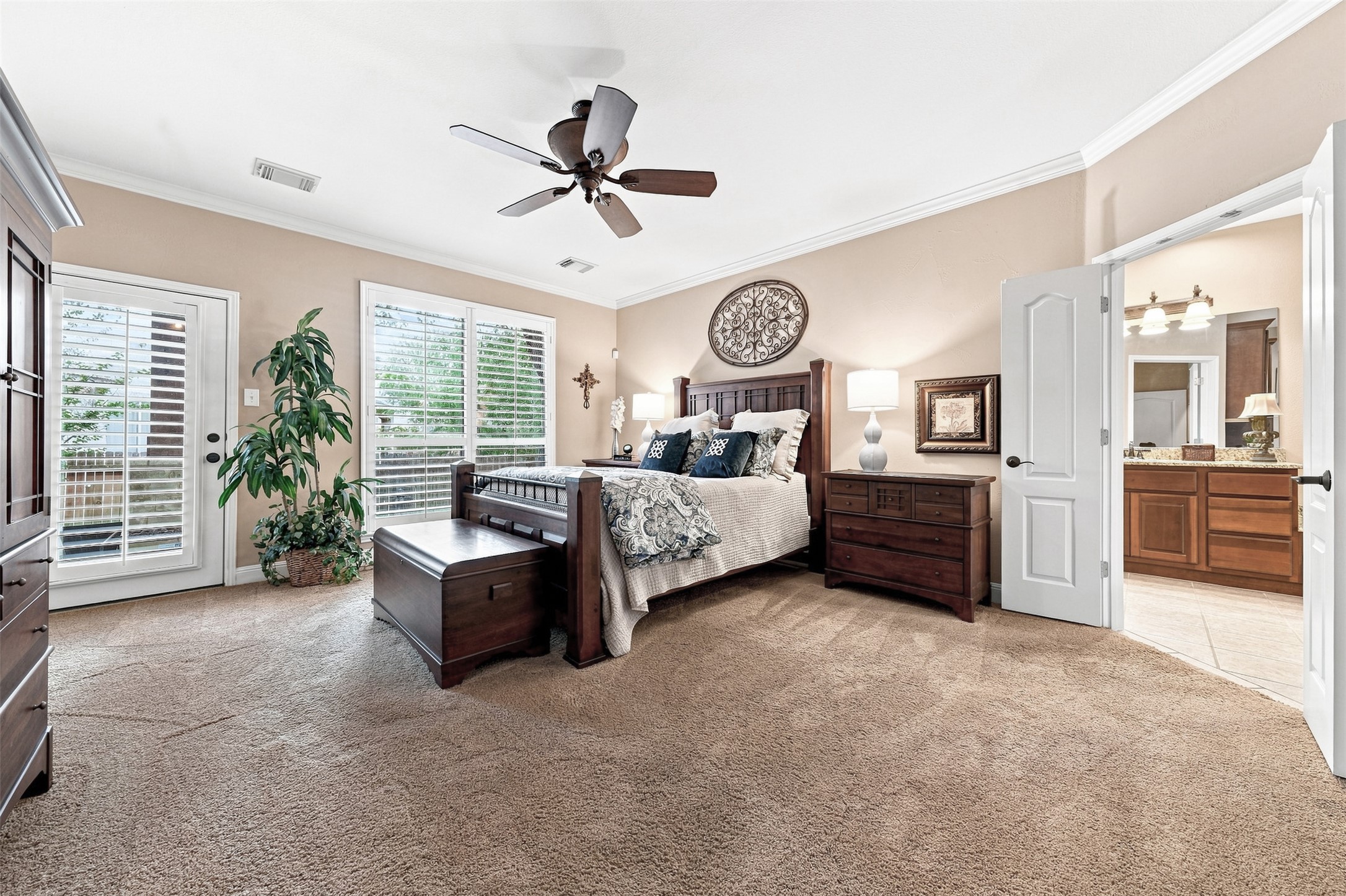 402 Ridgetop Bend Cedar Park, TX 78613 - Photo 21 of 40 Crown molding and plush carpeting define this spacious main bedroom suite with adjacent bath.