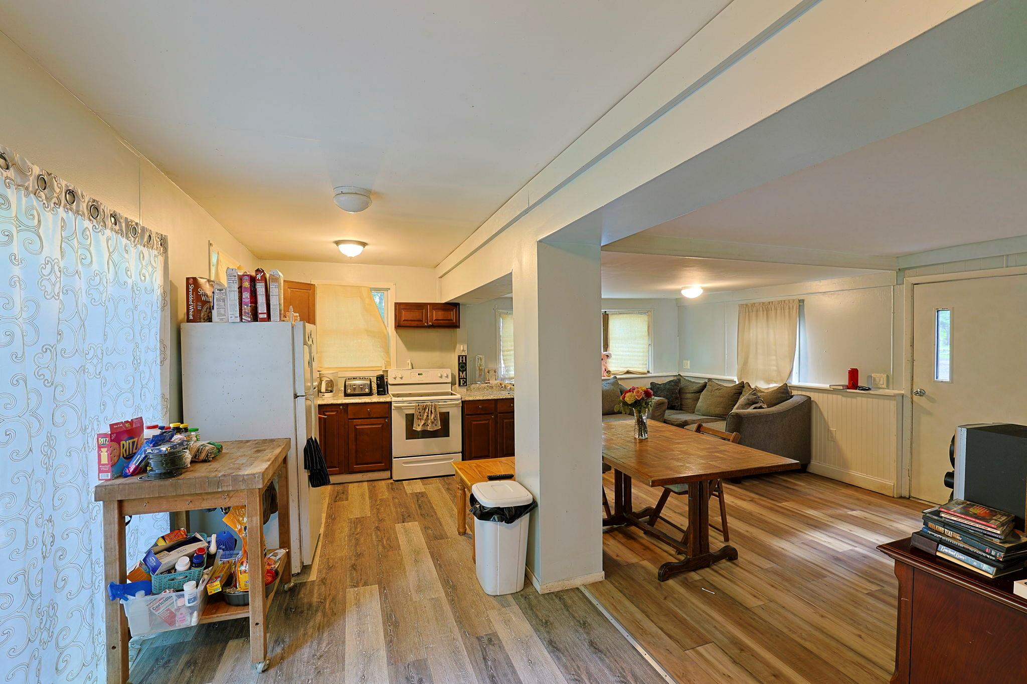 181 Oak Ridge Road Greenfield Park, NY 12435 - Photo 22 of 22 Kitchen with light wood finished floors, white appliances, open floor plan, and light countertops
