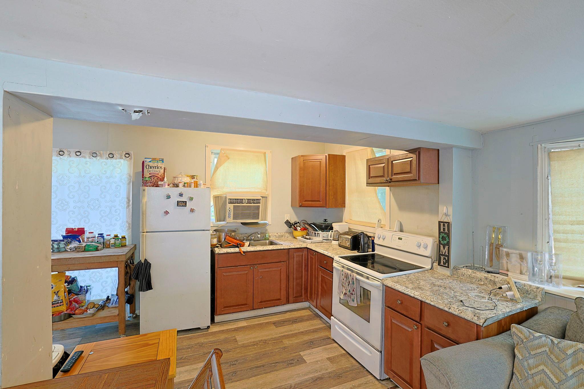 181 Oak Ridge Road Greenfield Park, NY 12435 - Photo 11 of 22 Kitchen featuring light stone counters, white appliances, brown cabinets, and light wood finished floors