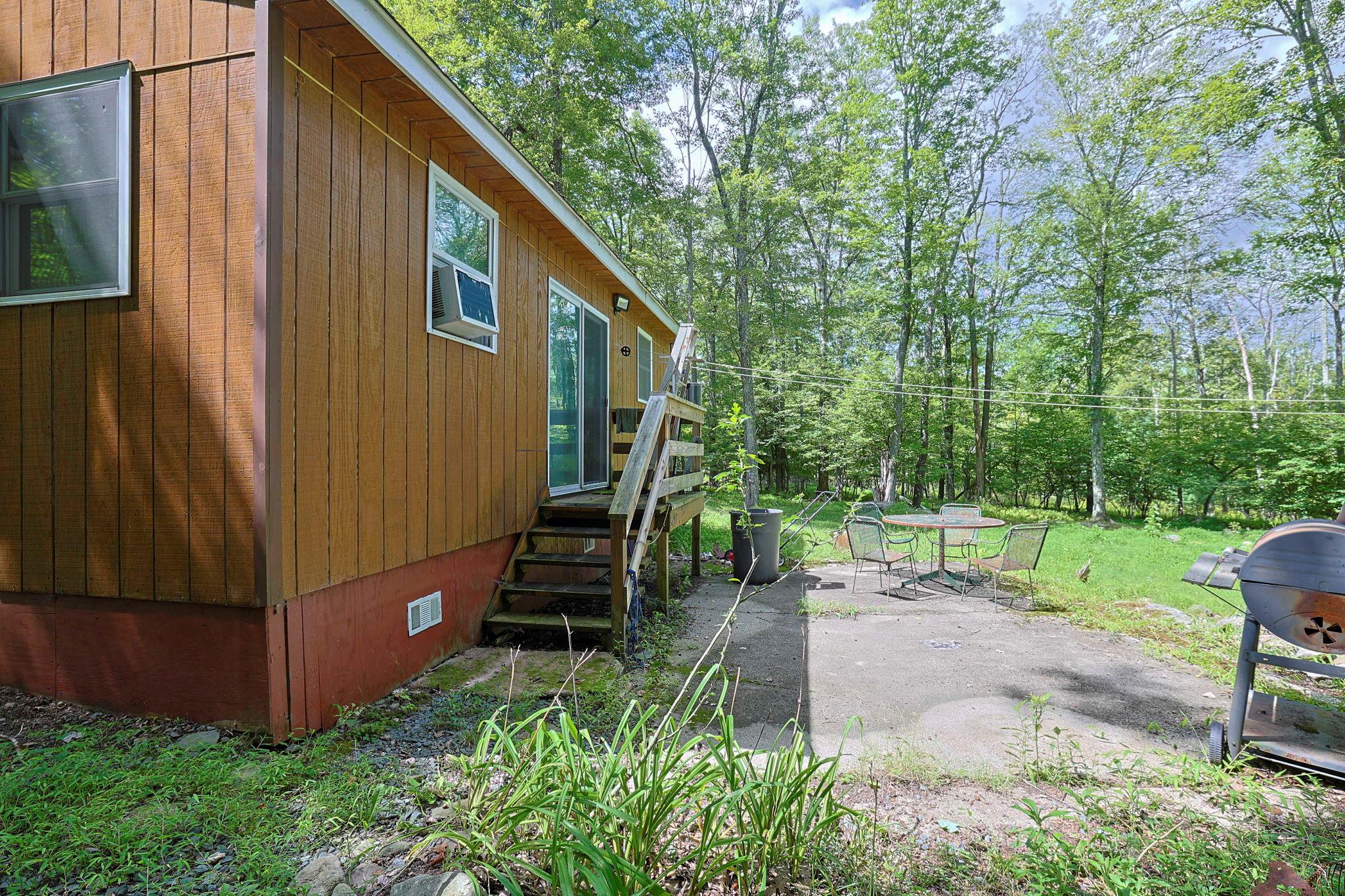 181 Oak Ridge Road Greenfield Park, NY 12435 - Photo 19 of 22 View of side of home featuring crawl space, a patio, and a lawn