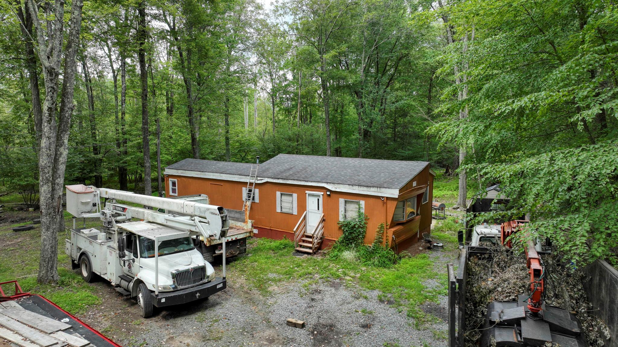 181 Oak Ridge Road Greenfield Park, NY 12435 - Photo 2 of 22 View of front of house with entry steps, a wooded view, and a shingled roof