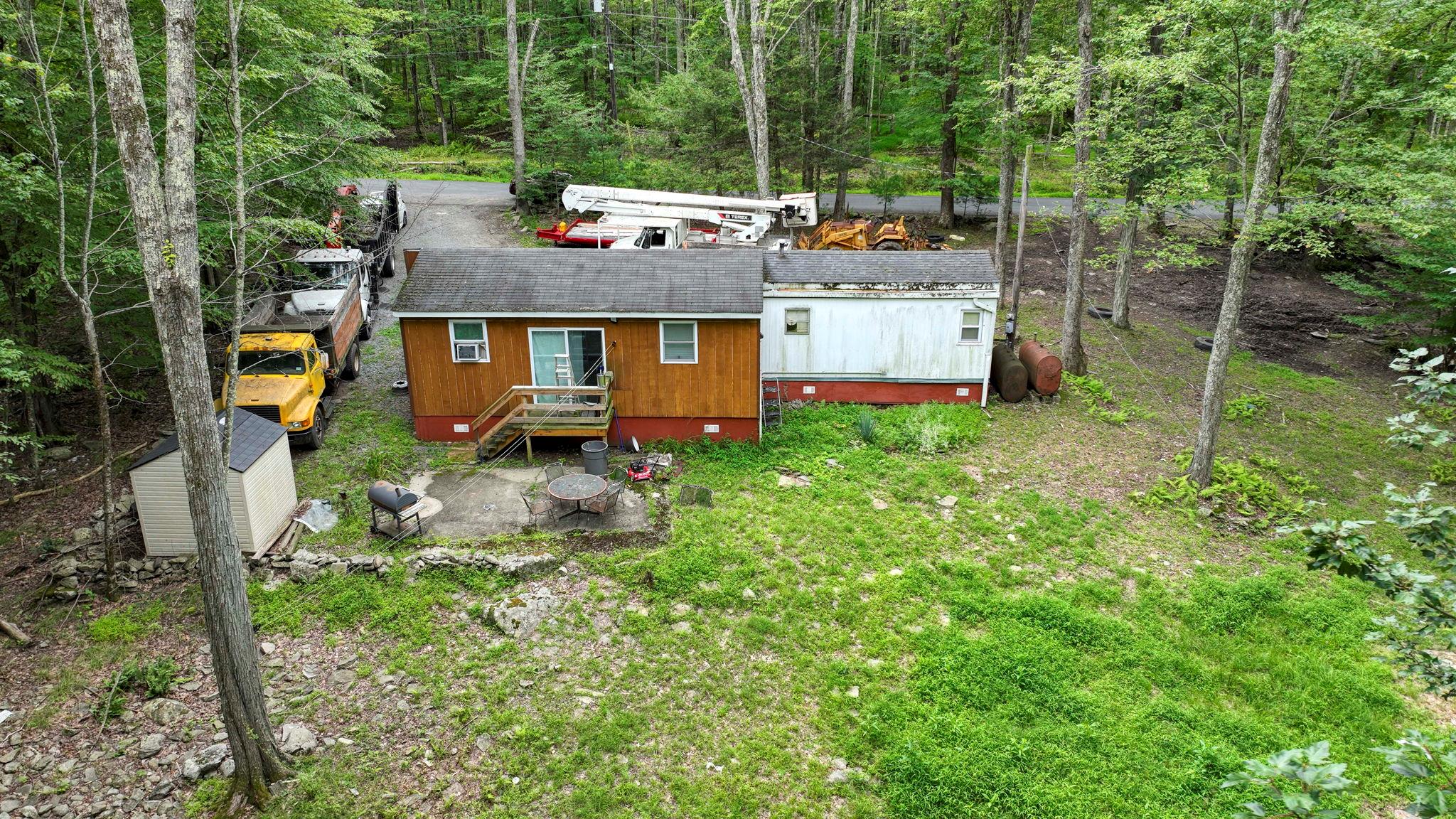 181 Oak Ridge Road Greenfield Park, NY 12435 - Photo 6 of 22 Back of house with crawl space, a view of trees, and roof with shingles
