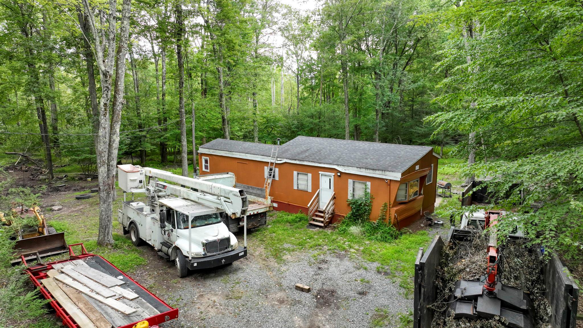 181 Oak Ridge Road Greenfield Park, NY 12435 - Photo 7 of 22 View of front facade featuring a garden, a view of trees, a shingled roof, and entry steps
