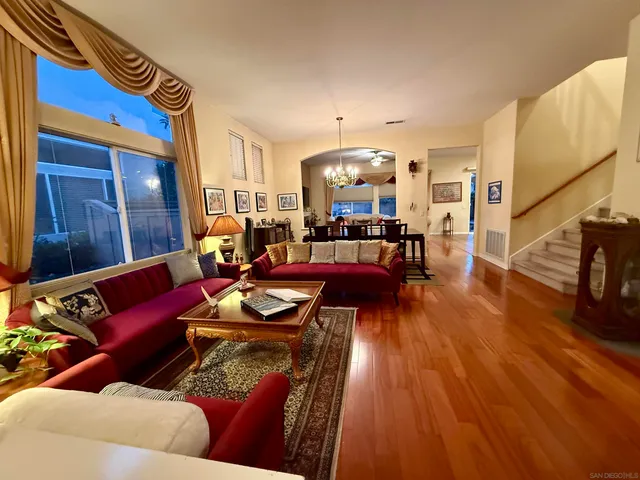 a living room with furniture and wooden floor
