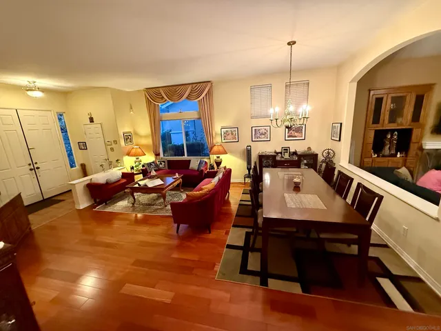 a living room with furniture a rug and a chandelier
