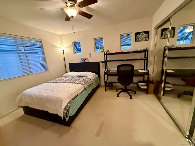 a bedroom with a bed and a desk