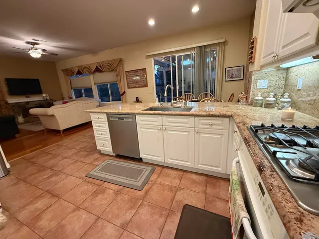 a kitchen with a sink and a stove top oven