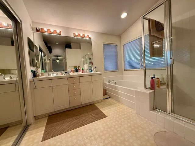 a bedroom with bed and a chandelier