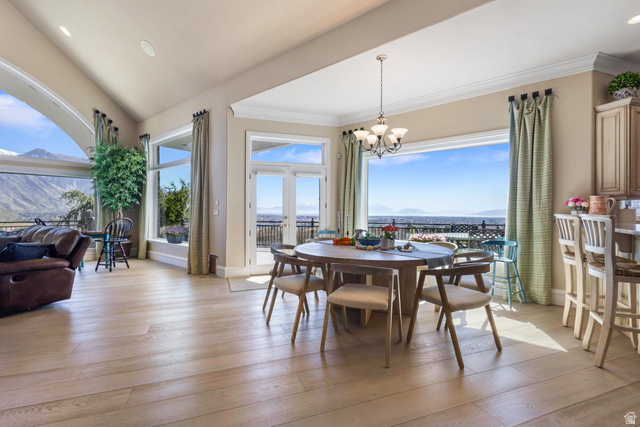 684 North Summit Way Alpine, UT 84004 - Photo 23 of 58 Dining area featuring healthy amount of natural light, light wood-style floors, suspended lighting, crown molding, and a mountain view