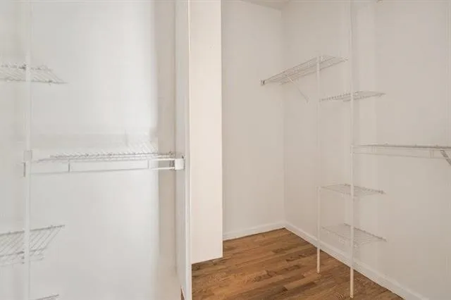 a view of walk in closet with empty racks