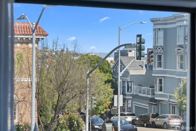 a view of a dining room with furniture a chandelier and wooden floor