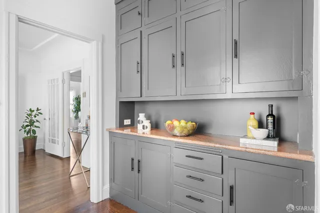 a bedroom with a large bed and a potted plant