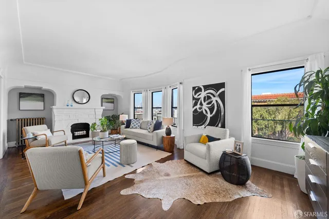 a living room with furniture fireplace and a window