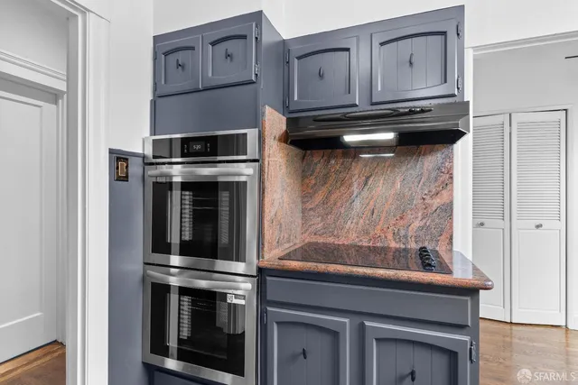 a bedroom with a bed and a flat tv screen on the dresser