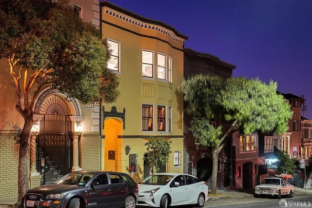 a couple of cars parked in front of a building