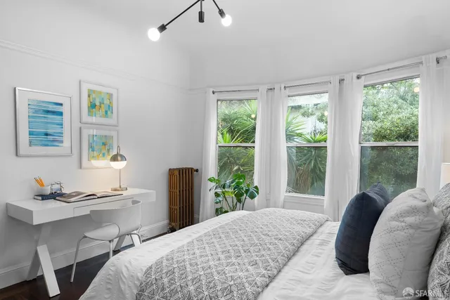 a living room with a couch and potted plant
